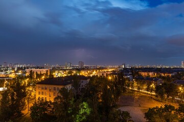 Fototapeta na wymiar Lightning strike over Kiev in purple.