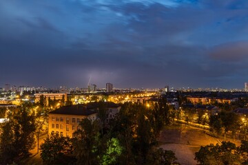 Fototapeta na wymiar Lightning strike over Kiev in purple.