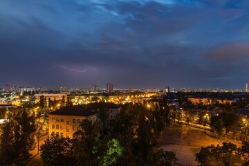 Fototapeta premium Lightning strike over Kiev in purple.