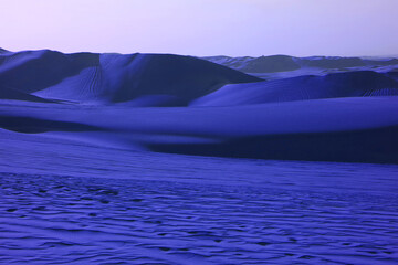 Fototapeta na wymiar Pop art surreal style royal blue colored desert with fantastic sand ripples and sand dunes
