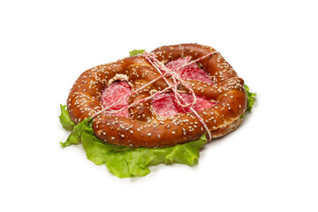 Pretzel with salami and lettuce isolated on a white background.