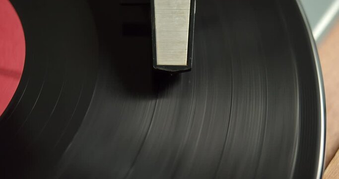 Close-up of a spinning vinyl record and pickup. Retro music albums of the last century on vinyl records.