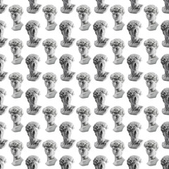 Seamless pattern from gypsum statue of David's head. Michelangelo's David statue plaster copy isolated on white background. Ancient greek sculpture, statue of hero