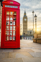 Fototapeta na wymiar Big Ben at sunrise with red telephone booth in London. England