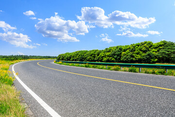 Asphalt road and green forest natural scenery.Highways and natural backgrounds.