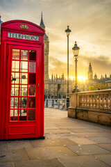 Fototapeta na wymiar Red telephone booth at sunrise in London. England