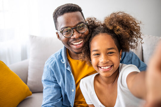 Family is the most important thing. Self portrait of young father and his little daughter smiling. Smiling father with little cute preschool daughter looking at smartphone screen taking making selfie