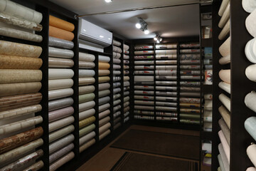 Assortment of stylish wall papers in shop