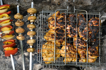 Grilled meat and vegetables. Tasty chicken with golden crust and grilled vegetables skewers.