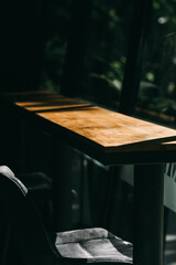Wooden Table With Old Chair In Vintage Bar With Sunlight And Nature Background 