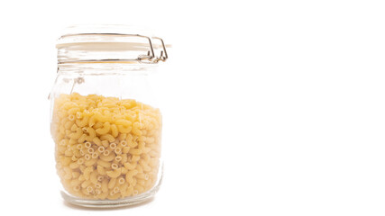 Isolated, The uncooked macaroni in the glass bottle on the white background