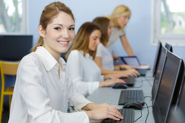 female student in computer class - Powered by Adobe