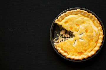 Homemade Chicken Pot Pie on a black background, top view. Flat lay, overhead, from above. Copy space.