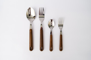 set cutlery of spoon, and fork, with a wood vintage handle on the white background 