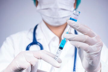 Doctor holds syringe and coronavirus vaccine bottle,concept of corona virus treatment