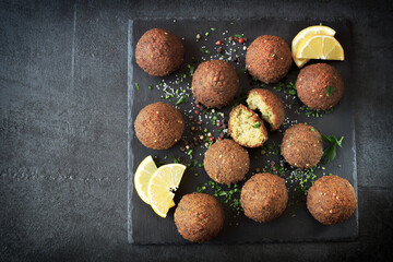 Falafels on a dark surface. Middle Eastern food. Israeli cuisine.