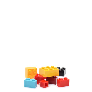 Colorful plastic lego brics closed up isolated on white