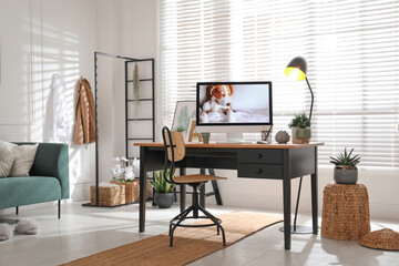 Stylish home office interior with sofa and comfortable workplace