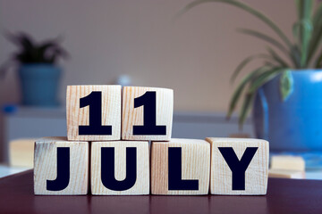 July 11 - from wooden blocks with letters, important date concept