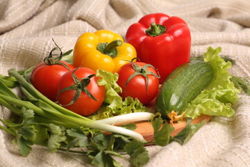 fresh appetizing bright vegetables and greens on a wooden board