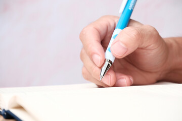 hand with pen writing