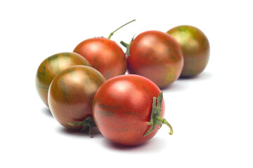 a row of tomatoes zebra ripe and not ripe isolated on a white background