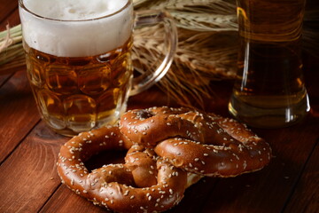 Bavarian freshly baked  homemade soft pretzel with beer. Rustic style. Oktoberfest