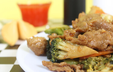 Beef Broccoli and Egg Roll on Plate in Chinese Restaurant