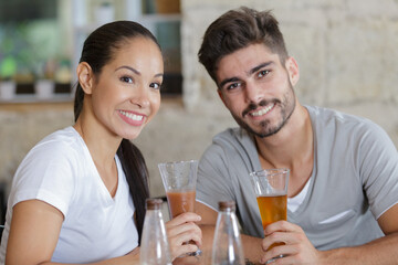 portrait of young couple having a drink in a bar