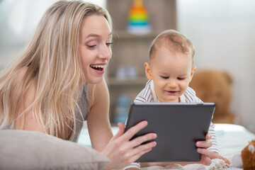 a mother with her baby looking at digital tablet