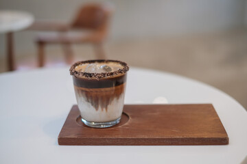 Dirty Coffee - A glass of espresso shot mixed with cold fresh milk in coffee shop cafe and restaurant