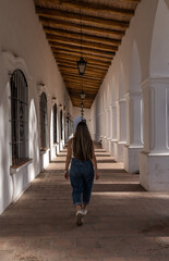 Vertical shot of a girl walking in the Archaeological Museum Pio Pablo Diaz Cachi, Salta, Argentina