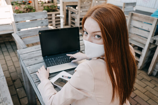 Outdoor Work Areas, Workplace. Take Office Outside, Work Moves Outdoors During Pandemic. Mobility, Autonomy, Work Remotely. Redhead Business Woman Working At Laptop Outdoors