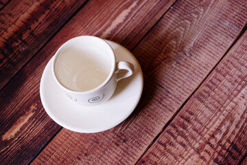 Empty coffee cup on a wooden background.