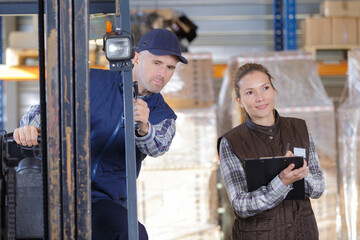 man and woman next to a forklift © auremar