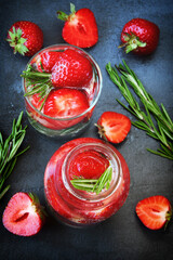 Detox drink with strawberries and rosemary. Mineral water with strawberries.