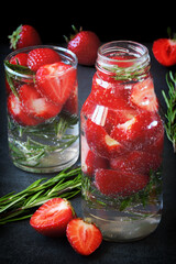 Detox drink with strawberries and rosemary. Mineral water with strawberries.