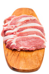 chopped into pieces raw pork on a wooden cutting board on a white background.