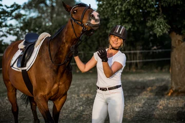 Foto op Canvas Smiling young woman and a flirty horse pose looking at camera. Happy together. Concept of happiness and enjoyment of life. Active recreation. © Татьяна Волкова