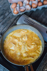 making scrambled eggs while camping