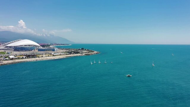 Aerial view Football stadium Fischt. Sochi, Adler, Russia. Cityscape modern olympic park new sports buildings epic dome. Futuristic architecture. Cinematic Russia landmark. Blue sea coastal area. 