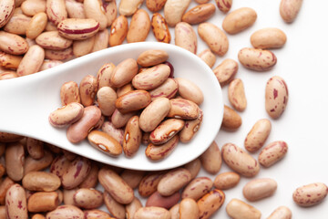 macro Close-up of Organic Lobia,  ( Lobia ) or kidney beans dal on a white ceramic soup spoon. Top view,  over gradient background of itself.