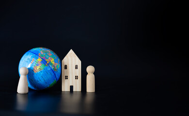 Model wooden houses and miniature globes Blank on a black background. Propose the concept of...