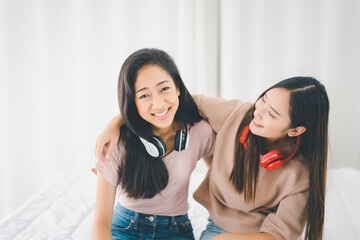 Two young asian women listening to music at home together,Happy and smiling,Lesbian,LGBT