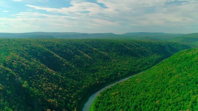 Aerial video of clouds, mountains, forest and mountain river