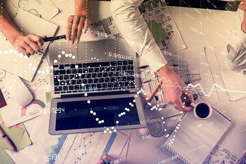 Double exposure of man and woman working together and technology theme drawing hologram. Big data concept. Computer background.