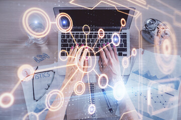Double exposure of woman hands working on computer and social network theme hologram drawing. Top View. People connection concept.