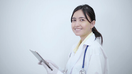 Female doctor  touch tablet screen searching report or disease information.