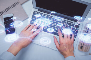Double exposure of woman hands working on computer and social network theme hologram drawing. Top View. People connection concept.