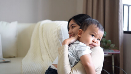 Asian cute boy kid hugging, embracing his mom.